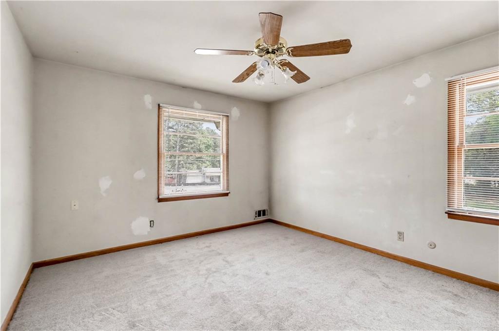 1315 Fairview Road Ellenwood, GA 30294 - Photo 20 of 34 an empty room with windows and fan