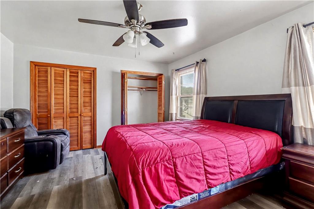 1315 Fairview Road Ellenwood, GA 30294 - Photo 21 of 34 a bedroom with a bed and wooden floor