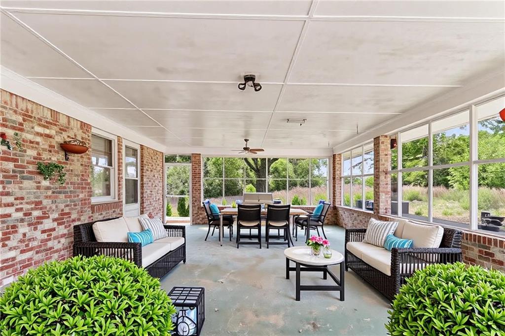 1315 Fairview Road Ellenwood, GA 30294 - Photo 25 of 34 a living room with patio furniture and a potted plants