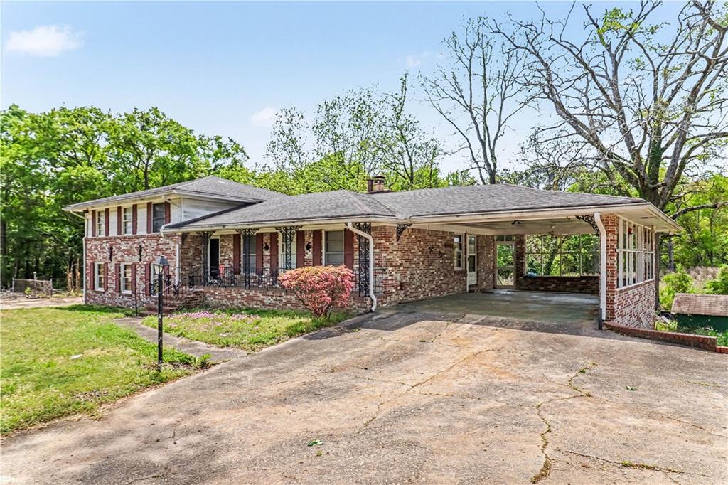 1315 Fairview Road Ellenwood, GA 30294 - Photo 3 of 34 a front view of a house with a yard and porch