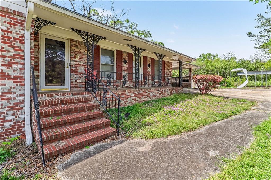 1315 Fairview Road Ellenwood, GA 30294 - Photo 5 of 34 a front view of a house with garden