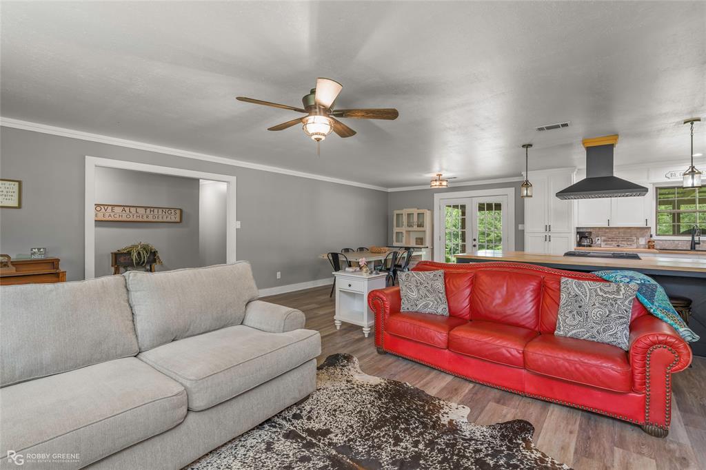 1426 Caney Lake Road Minden, LA 71055 - Photo 3 of 36 Spacious living area featuring wood-finish flooring and a ceiling fan