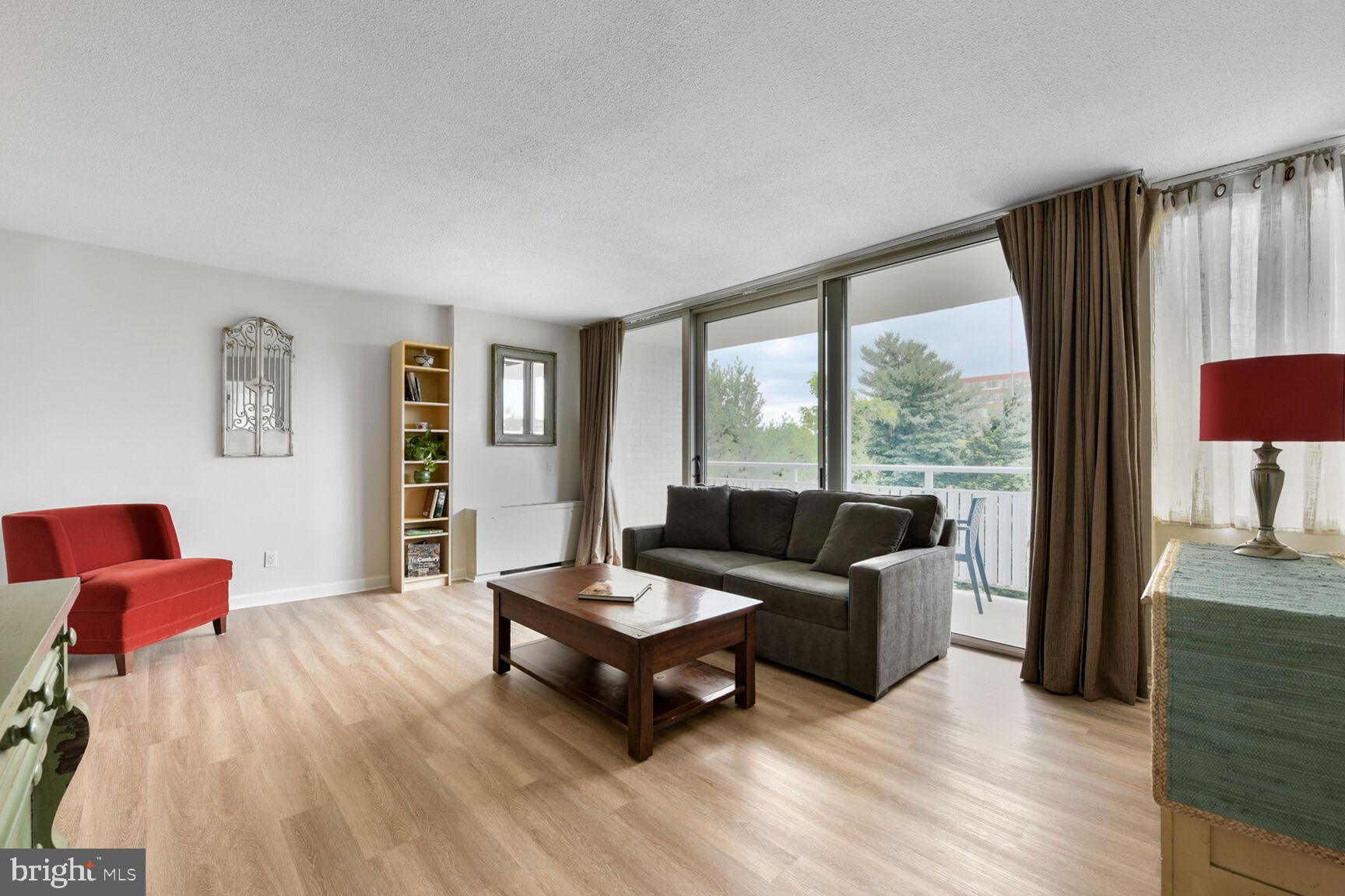 1301 South Arlington Ridge Road, Unit 404 Arlington, VA 22202 - Photo 5 of 43 a living room with furniture and a floor to ceiling window