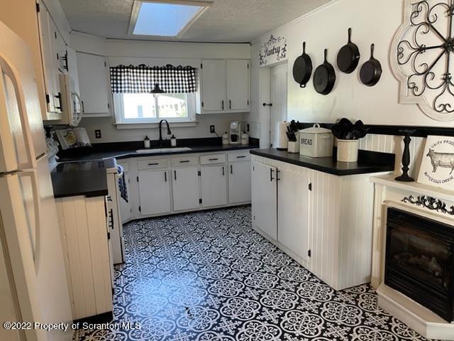 991 Main Street Rome, PA 18837 - Photo 26 of 53 a kitchen with stainless steel appliances a stove a sink a refrigerator a window and cabinets