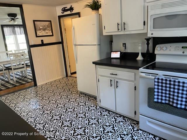 991 Main Street Rome, PA 18837 - Photo 27 of 53 a kitchen with a sink a refrigerator and cabinets