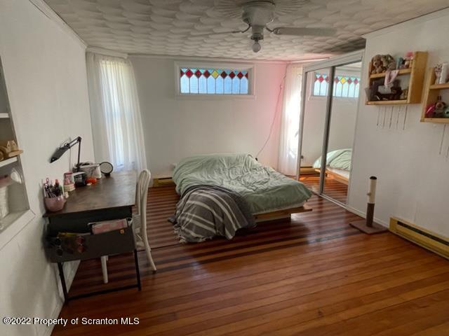 991 Main Street Rome, PA 18837 - Photo 32 of 53 a bedroom with a bed and wooden floor