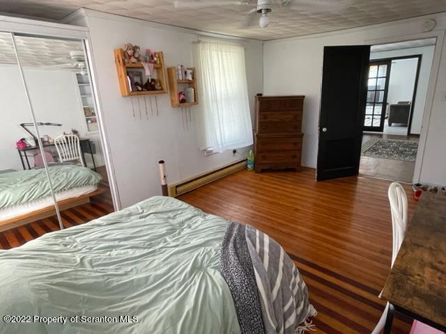 991 Main Street Rome, PA 18837 - Photo 36 of 53 a bedroom with a bed and wooden floor