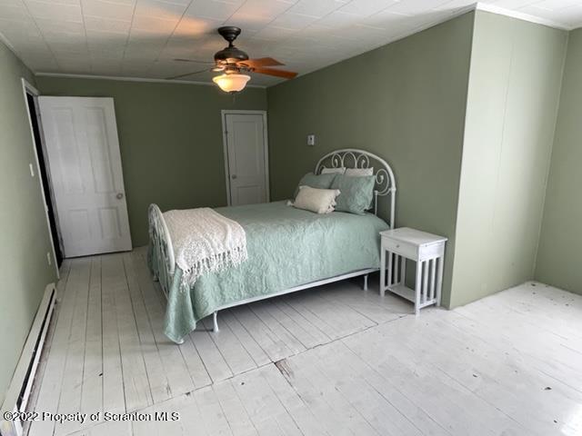 991 Main Street Rome, PA 18837 - Photo 37 of 53 a bedroom with a bed and a chandelier