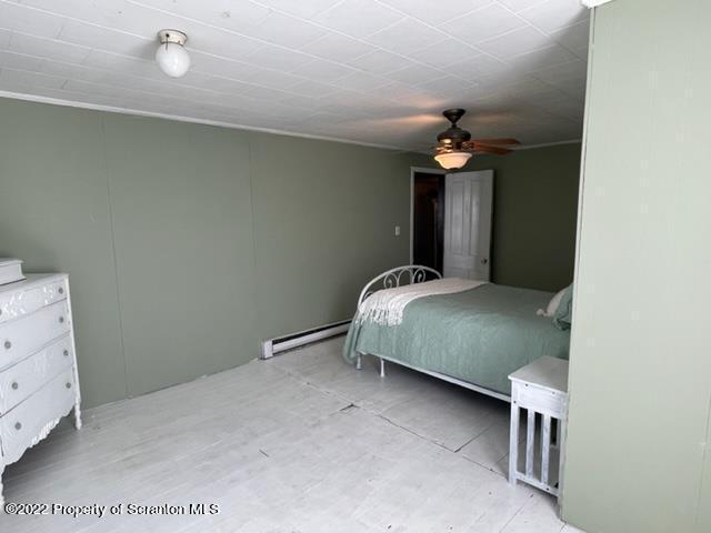 991 Main Street Rome, PA 18837 - Photo 38 of 53 a bedroom with a bed and a chandelier