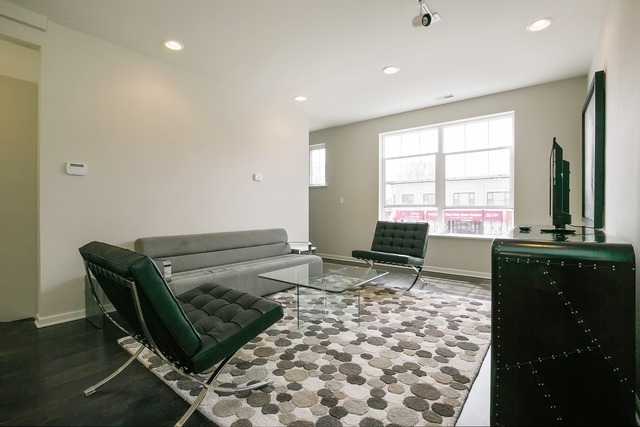 2314 East 71st Street, Unit B Chicago, IL 60649 - Photo 2 of 19 a living room with a couch and a table