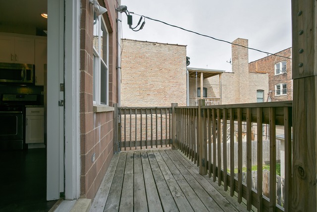 2314 East 71st Street, Unit B Chicago, IL 60649 - Photo 14 of 19 a view of a balcony with wooden floor