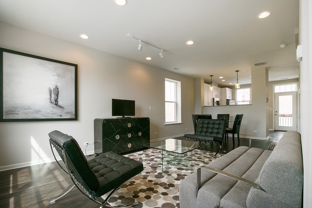 2314 East 71st Street, Unit B Chicago, IL 60649 - Photo 3 of 19 a living room with furniture and a flat screen tv