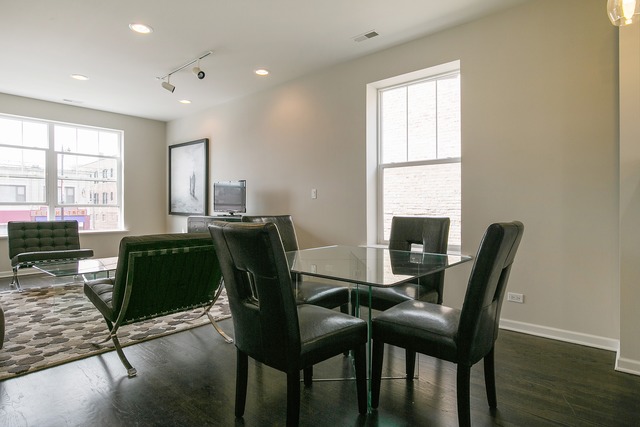2314 East 71st Street, Unit B Chicago, IL 60649 - Photo 4 of 19 a view of a dining room with furniture and wooden floor