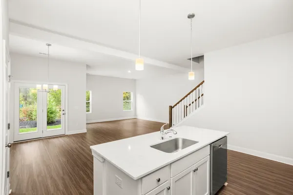 a kitchen with a sink and a hard wood floor