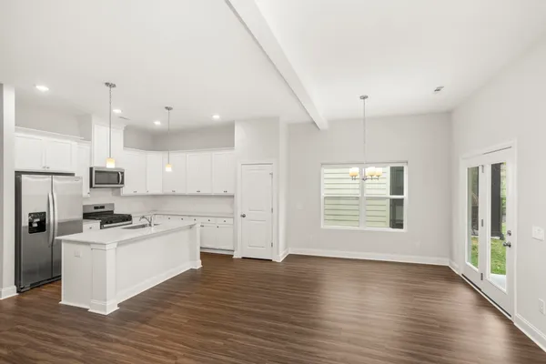 a kitchen with stainless steel appliances a stove top oven a sink and a refrigerator