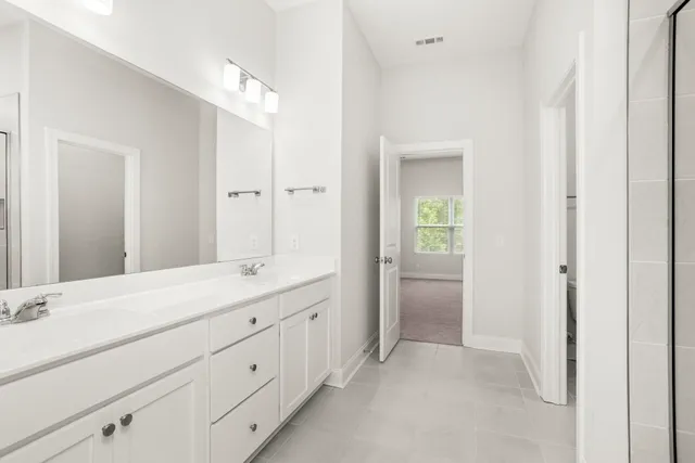 a bathroom with a double vanity sink and mirror