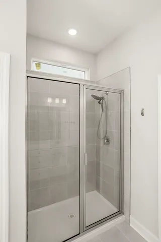 a bathroom with a glass shower door