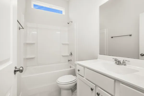 a bathroom with a sink toilet vanity and shower