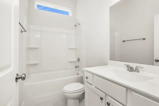 a bathroom with a sink toilet vanity and shower