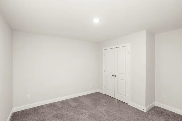 an empty room with white wall and white door
