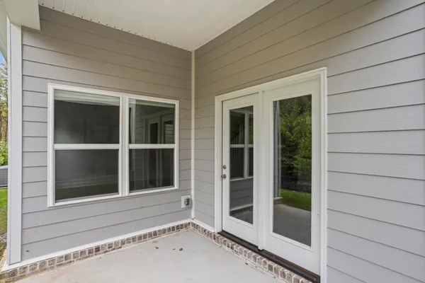 a view of a house with backyard and porch
