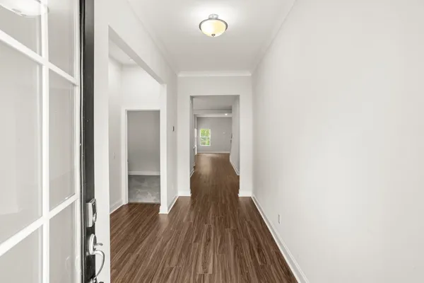 a view of a hallway with wooden floor