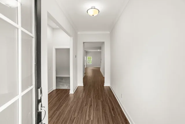 a view of a hallway with wooden floor
