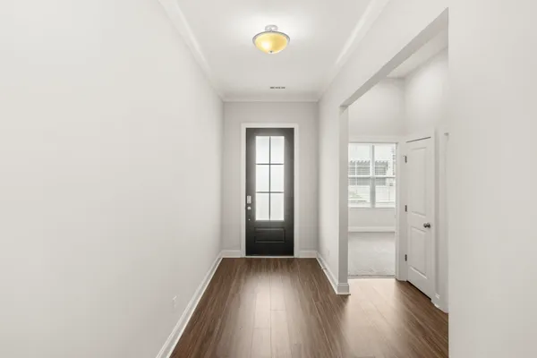 a view of empty room with wooden floor