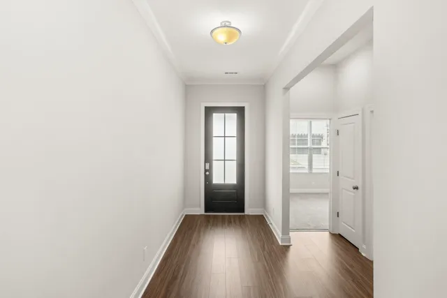 a view of empty room with wooden floor
