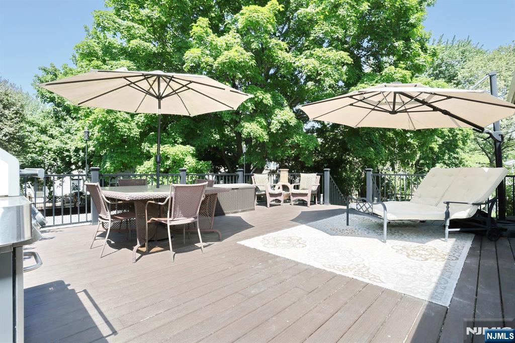 30 Brookfield Road Dumont, NJ 07628 - Photo 35 of 50 a view of backyard with table and chairs under an umbrella