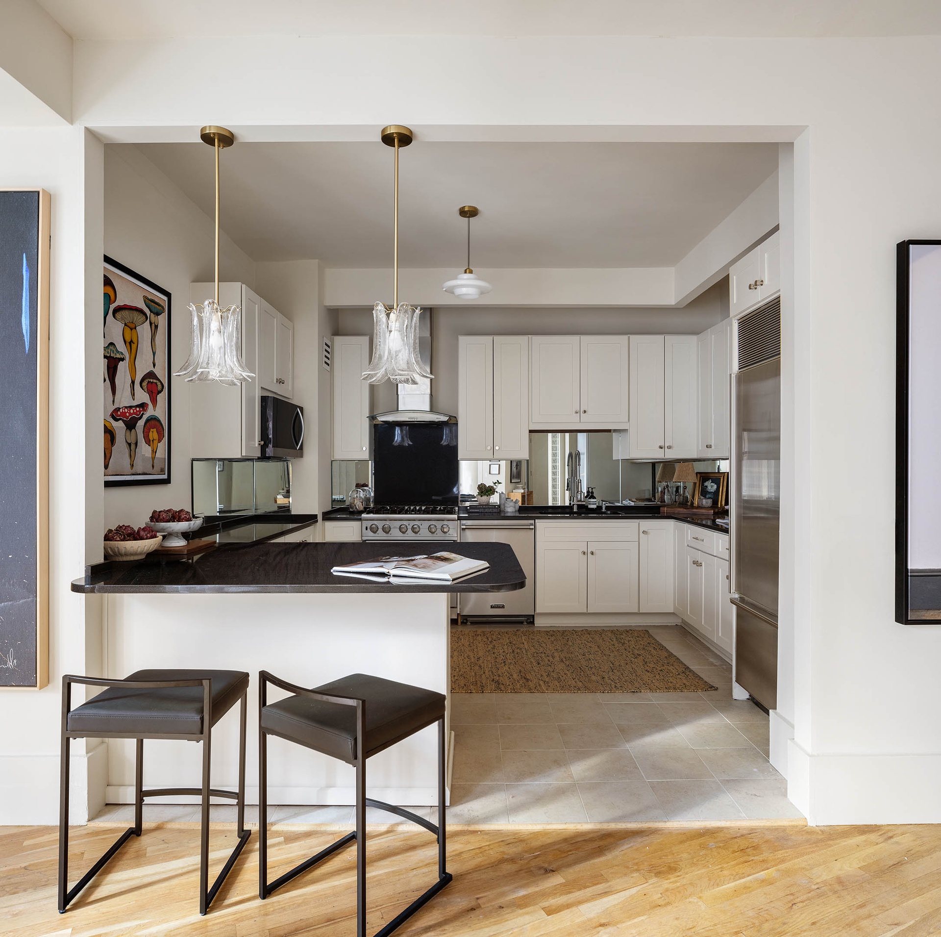 260 West Broadway, Unit 4C Manhattan, NY 10013 - Photo 11 of 28 a kitchen with kitchen island granite countertop a sink cabinets and stainless steel appliances