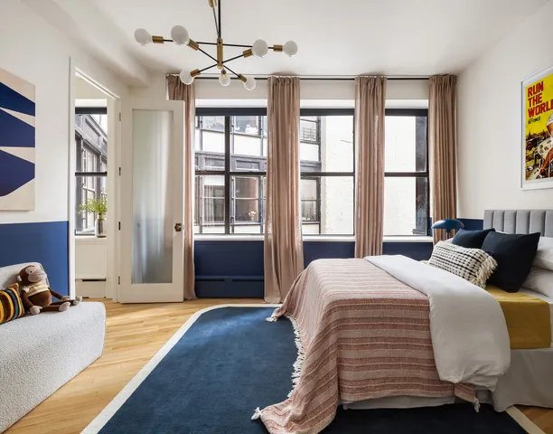 a bedroom with a bed dresser and a window