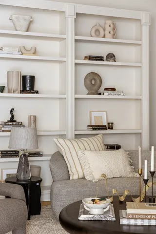 a living room with furniture and a book shelf