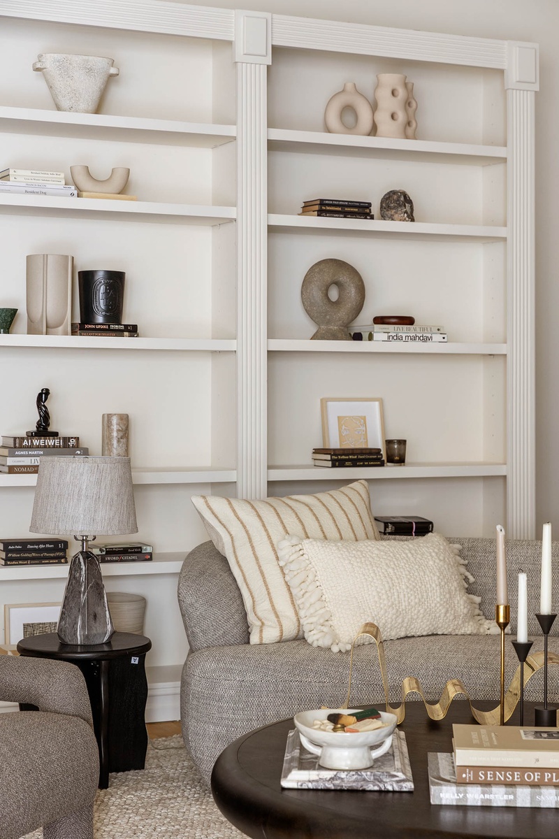 260 West Broadway, Unit 4C Manhattan, NY 10013 - Photo 5 of 28 a living room with furniture and a book shelf