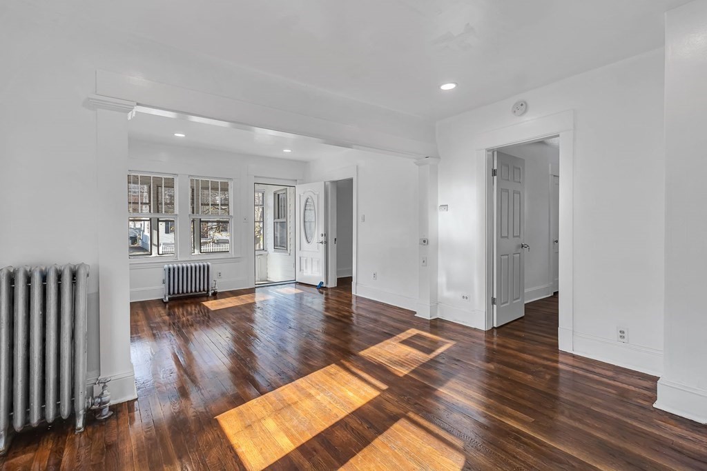 55 Redlands Street Springfield, MA 01104 - Photo 11 of 42 an empty room with wooden floor and windows