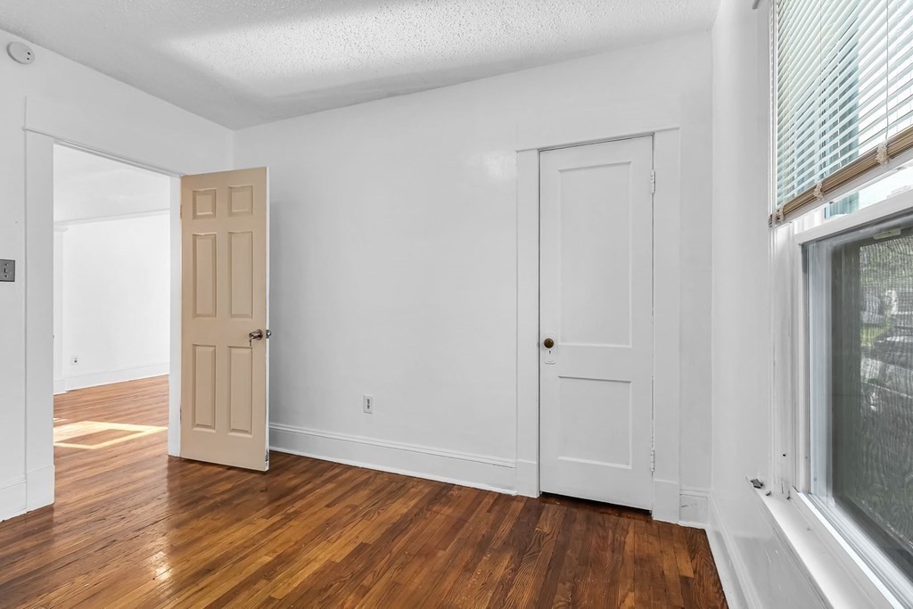 55 Redlands Street Springfield, MA 01104 - Photo 14 of 42 a view of an empty room with wooden floor and a window