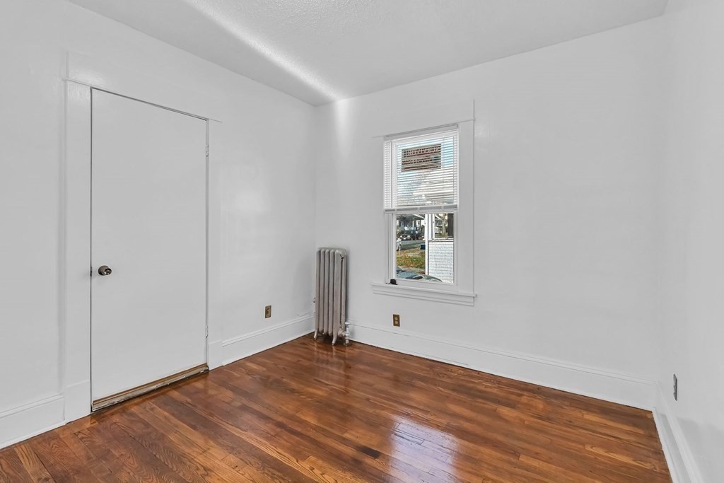 55 Redlands Street Springfield, MA 01104 - Photo 16 of 42 a view of empty room with wooden floor and fan