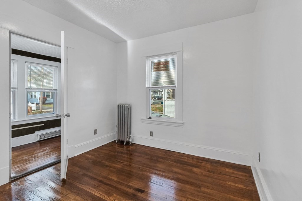55 Redlands Street Springfield, MA 01104 - Photo 17 of 42 wooden floor in an empty room with a window
