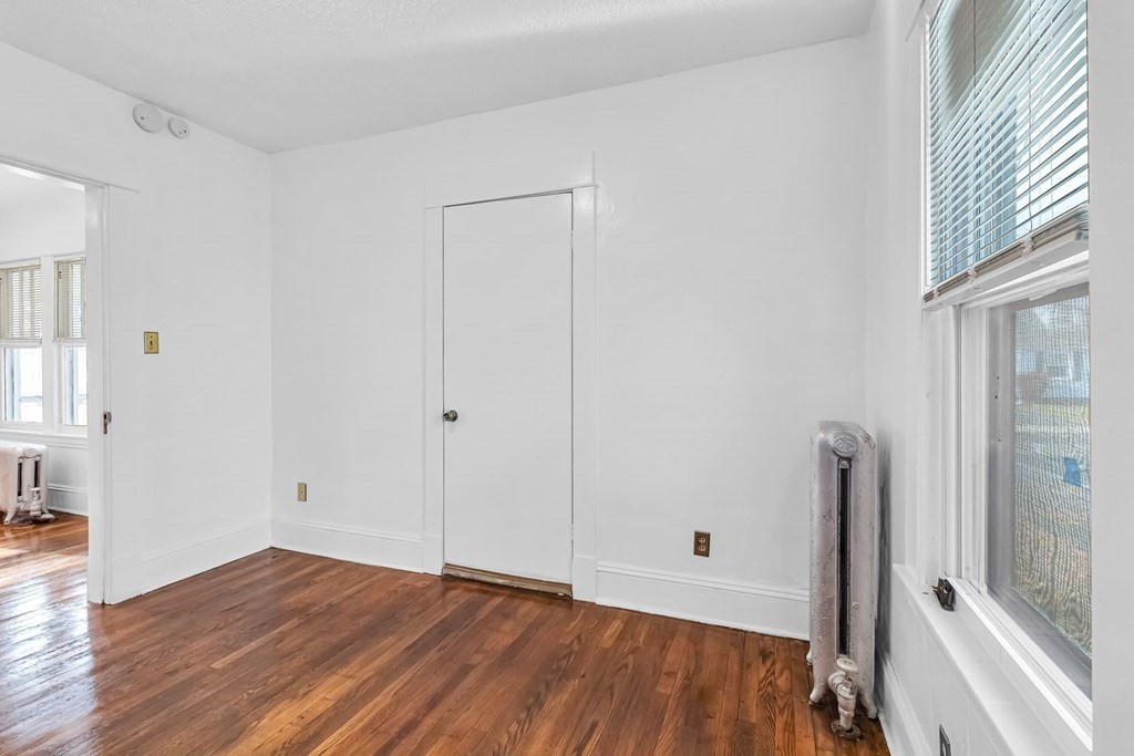 55 Redlands Street Springfield, MA 01104 - Photo 18 of 42 a view of an empty room with wooden floor and a window