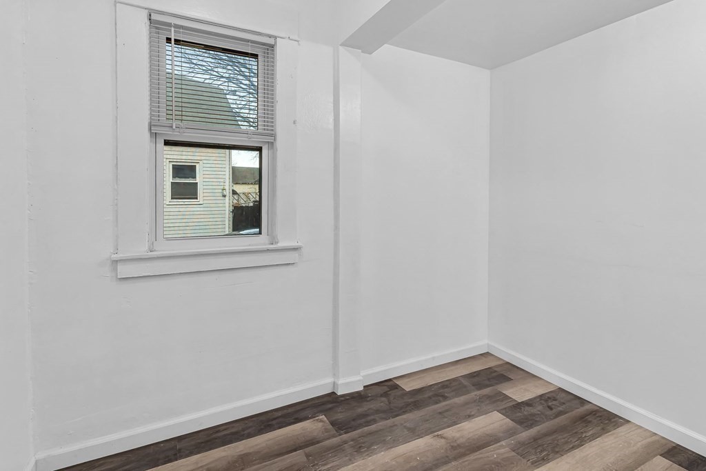 55 Redlands Street Springfield, MA 01104 - Photo 30 of 42 a view of an empty room with wooden floor and a window