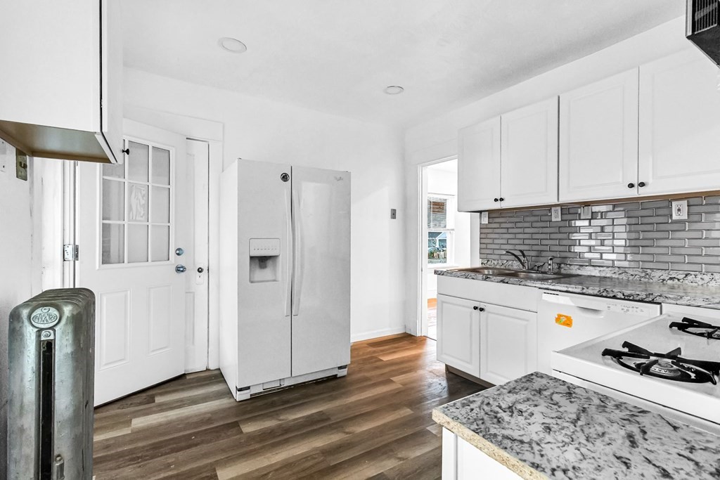 55 Redlands Street Springfield, MA 01104 - Photo 3 of 42 a kitchen with stainless steel appliances granite countertop a stove and a refrigerator
