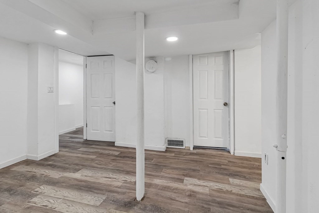 55 Redlands Street Springfield, MA 01104 - Photo 37 of 42 a view of a hallway with wooden floor