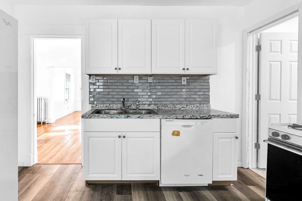 55 Redlands Street Springfield, MA 01104 - Photo 5 of 42 a kitchen with granite countertop white cabinets and white appliances