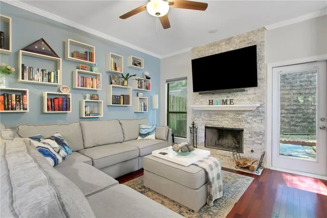 a living room with furniture fireplace and flat screen tv