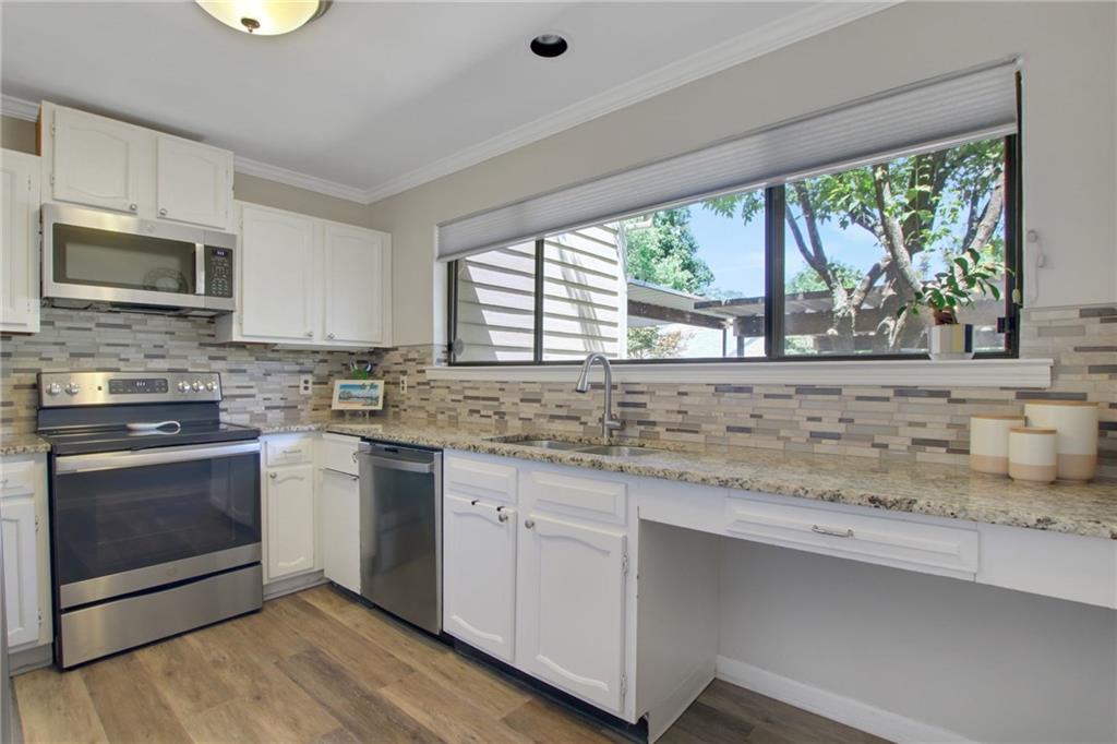 1929 Variations Drive Northeast Atlanta, GA 30329 - Photo 13 of 33 a kitchen with granite countertop a stove a sink and a microwave