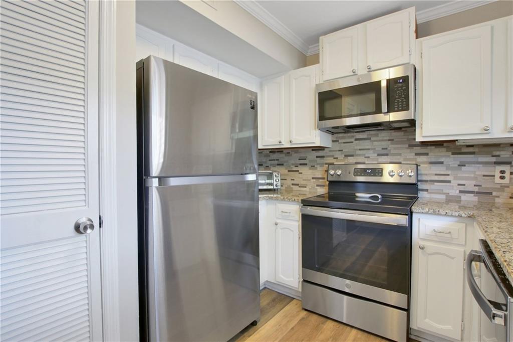 1929 Variations Drive Northeast Atlanta, GA 30329 - Photo 15 of 33 a kitchen with stainless steel appliances a stove microwave and refrigerator
