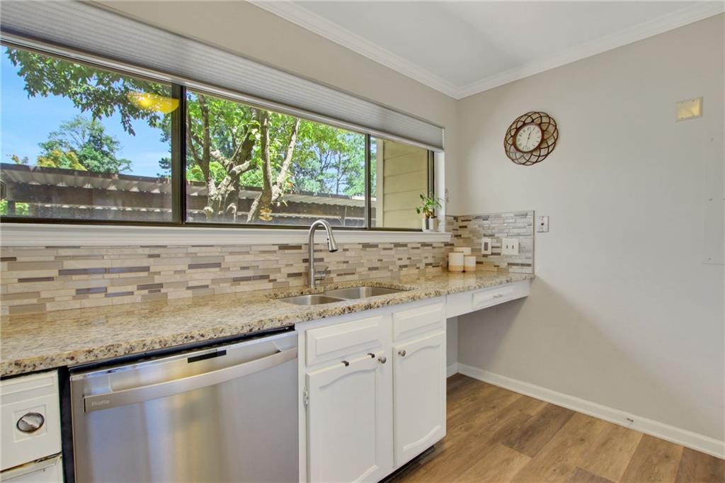 1929 Variations Drive Northeast Atlanta, GA 30329 - Photo 16 of 33 a kitchen with granite countertop stainless steel appliances white cabinets and a large window