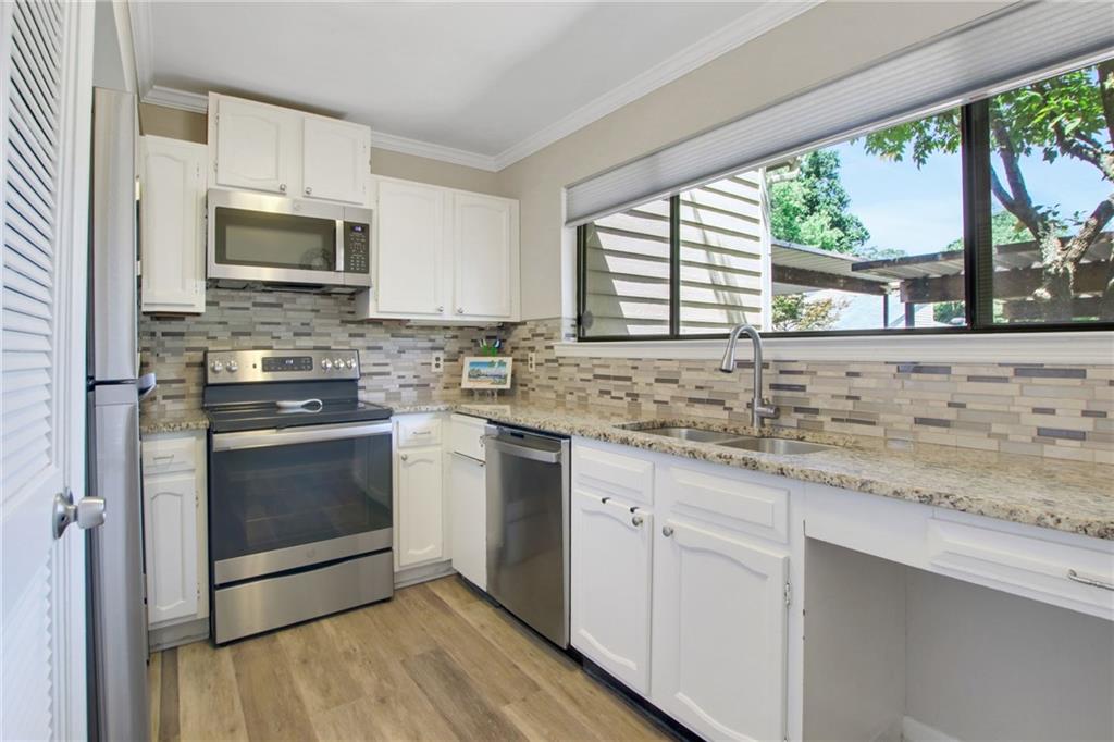 1929 Variations Drive Northeast Atlanta, GA 30329 - Photo 17 of 33 a kitchen with stainless steel appliances granite countertop a stove a sink and a microwave