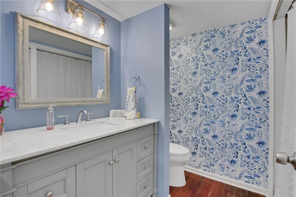 1929 Variations Drive Northeast Atlanta, GA 30329 - Photo 18 of 33 a bathroom with a granite countertop sink a toilet and a mirror