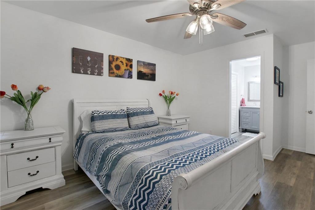 1929 Variations Drive Northeast Atlanta, GA 30329 - Photo 22 of 33 a bedroom with a large bed and a chandelier